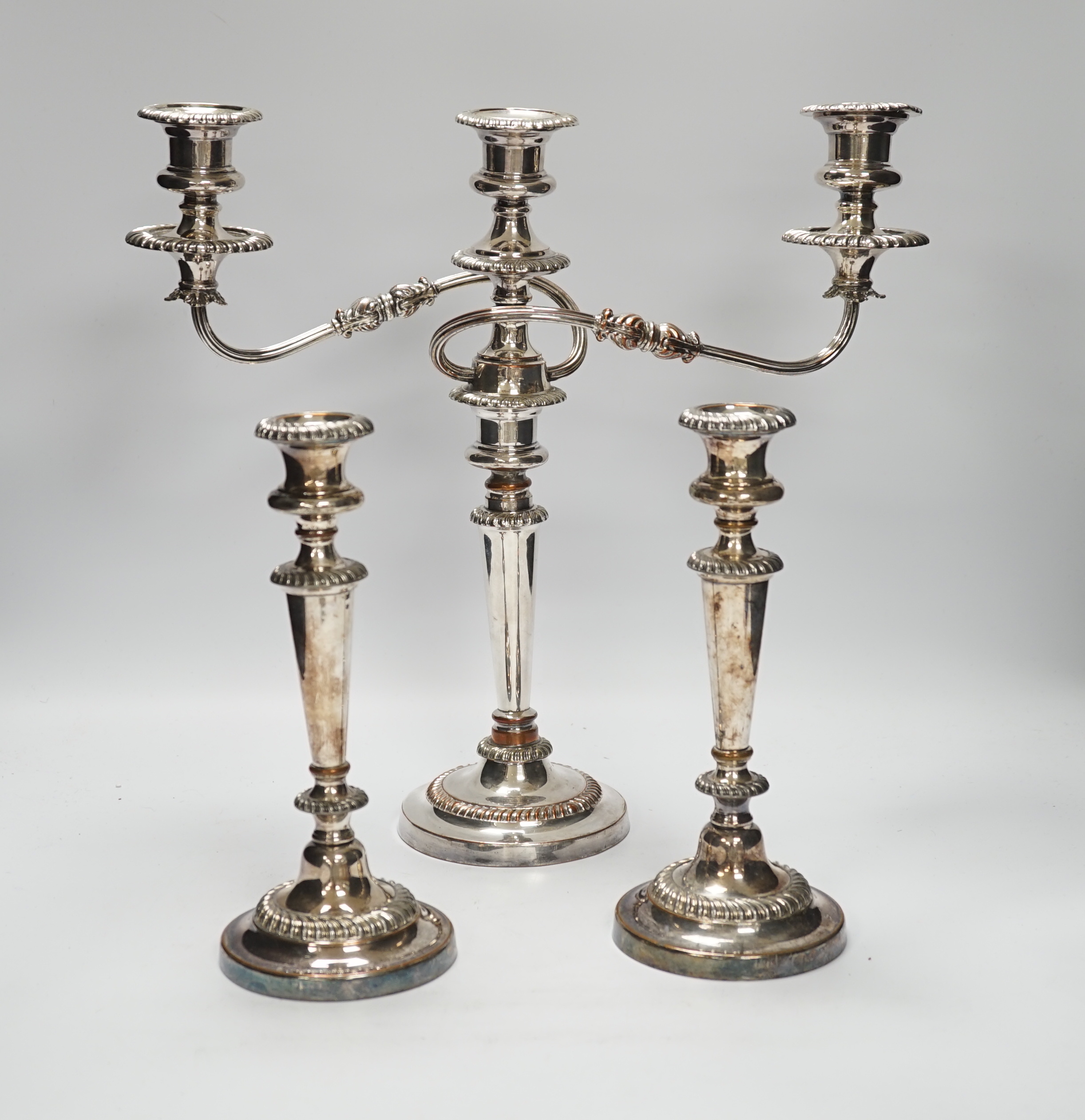 A Sheffield plate two branch, three light candelabra and a pair of candlesticks, candelabra 36cm high